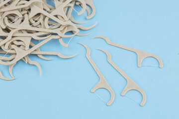 Eco friendly corn starch dental toothpick with dental floss on blue background