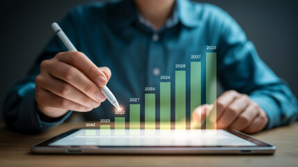 Person using stylus on tablet with holographic bar graph data image