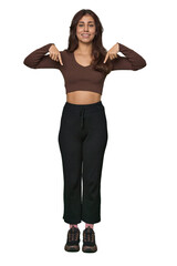 Middle Eastern woman, full body studio points down with fingers, positive feeling.