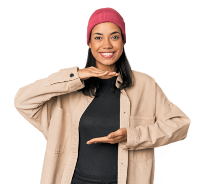 Young Filipino woman in studio holding something with both hands, product presentation.