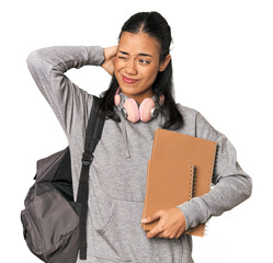 Young Filipino female student with books touching back of head, thinking and making a choice.