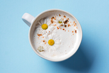 Chamomile moon milk on blue background