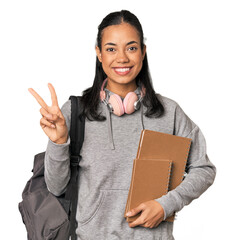 Young Filipino female student with books showing number two with fingers.