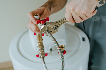 Man fixing water heater using wrench