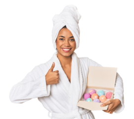 Young Filipino woman with foam balls smiling and raising thumb up