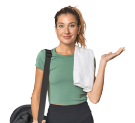 Blonde athlete with sports backpack showing a copy space on a palm and holding another hand on waist.