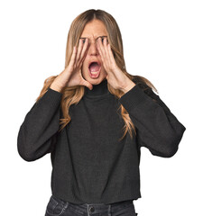 Caucasian blonde woman in studio shouting excited to front.