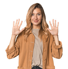 Caucasian blonde woman in studio showing number ten with hands.