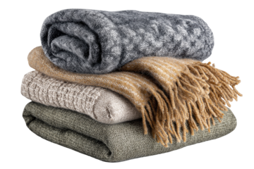 Stacked cozy blankets in muted tones