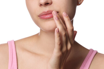 Fototapeta premium Young woman with lip balm on her lips against white background, closeup