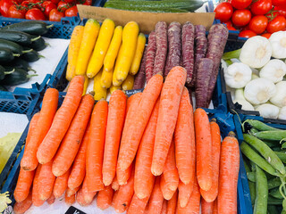 Various colors of carrots available in the Viktualienmarkt market in Munich, Germany.