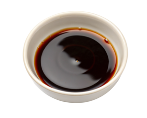 Soy sauce in white bowl against black background for Asian cuisine flavor seasoning in kitchen use
