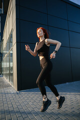 Obraz premium Active woman running outdoors in urban environment