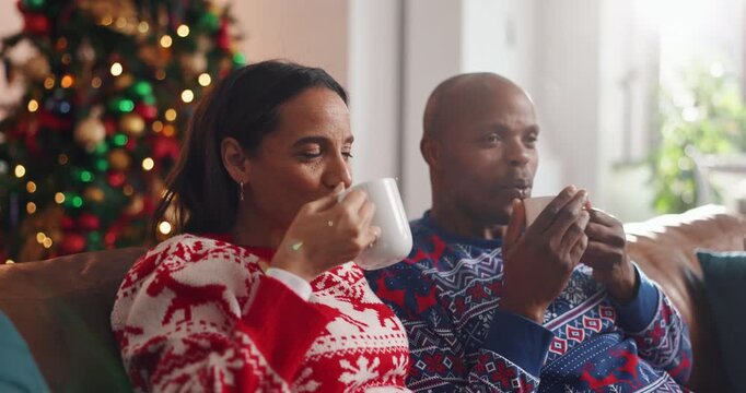 Christmas, coffee and African couple with toast, tree and love in living room of house together. Talk, smile and man with woman, xmas and holiday or vacation bonding for festive season or tradition