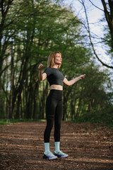Woman exercising in a serene forest setting