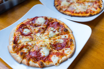 Fresh pizza slice served on white plate restaurant