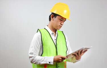 The head of construction supervision is checking the building construction report seriously and carefully, isolated on a white background.