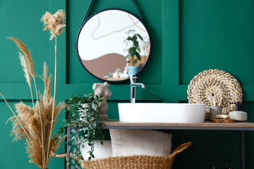 Table with sink and bath accessories in room