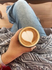 Selfie of women drinking coffee latte art milk foam on hand