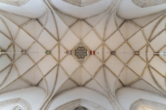 View of an ornate ceiling with diamond patterns and a central rosette, a symphony of architectural precision in graz cathedral, Graz, Steiermark, Austria.