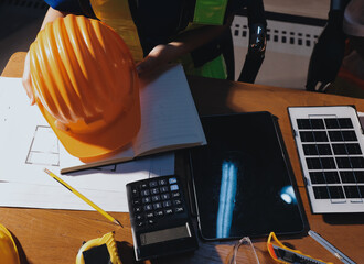 Closeup of team of industrial engineers meeting analyze machinery blueprints consult project on...