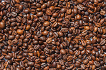 Roasted coffee beans as a background. Closeup. Macro photo top view.