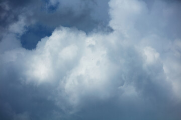 Dramatic Cloudy Sky with Bright and Dark Formations, Suggesting Dynamic Weather Conditions