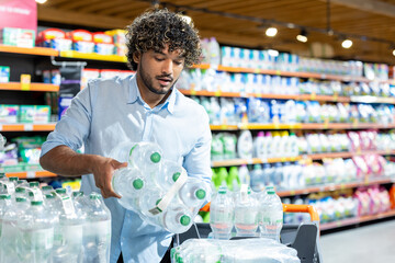 A man in a store grabs bottled water during a crisis where products are scarce