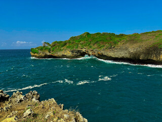 Coastal Vista: A panoramic view of a rugged coastline where the emerald sea meets the azure sky....