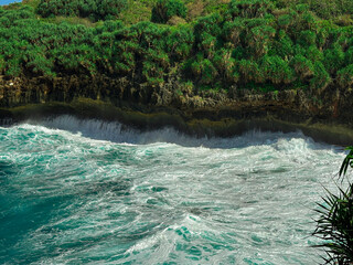 Ocean Waves Crashing: Captivating coastal scene where the rhythmic crashing of ocean waves against...