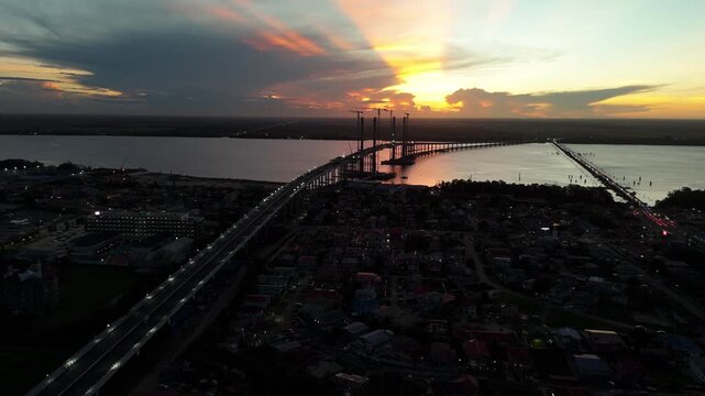 sunset over the river, new high span cable bridge completed in Guyana - 4K