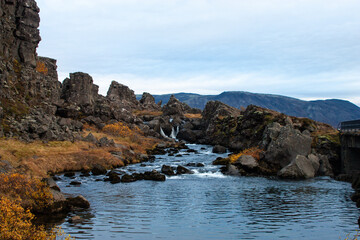 A breathtaking view of a majestic waterfall cascading over rugged rocks in the Crimean mountains,...