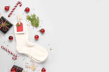 Beautiful composition with warm socks and Christmas decor on grey background