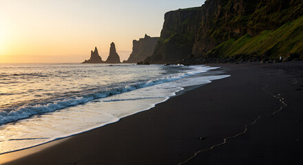 Stunning view of black sand beach and the Reynisdrangar sea stacks in Iceland at sunset, perfect for travel, nature, and majestic landscape themes.