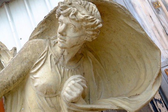 Paris, France, Europe.  The famous and worlds largest flea market - the St. Ouen "Marche des Puces.Stone angel sculpture