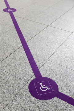 Floor decals for person with disability track at airport.