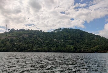 A tranquil midday lake view framed by reflective water