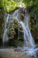  Peaceful waterfall in a Croatian national park surrounded by lush greenery and clear water. A...