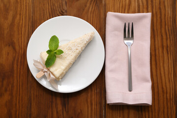 Plate with tasty cheesecake pop on wooden background