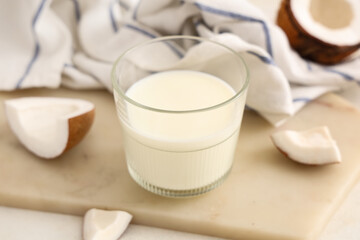Stone tray, napkin and glass of tasty coconut milk on white background, closeup