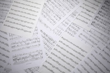 Fototapeta premium Sheets with musical notes as background, top view