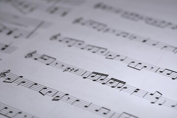 Sheet with musical notes as background, closeup