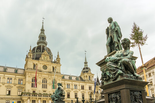 View of Erzherzog Johann fountain stands proudly before the historic city hall under a soft sky, a contrast of bronze and stone, Graz, Graz, Austria.