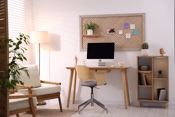 Stylish workplace with wooden desk and computer at home office. Interior design
