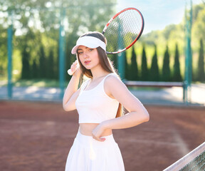 Beautiful woman with racket at tennis court