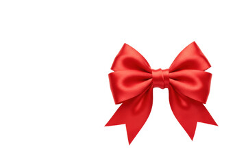 Fototapeta premium Pristine red satin bow, elegantly tied and meticulously formed from high-quality ribbon, against an expansive transparent background with copy space, high-key lighting. Concept of luxury and