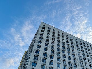 Fototapeta premium Apartment building on the background of blue sky, new building. High quality photo