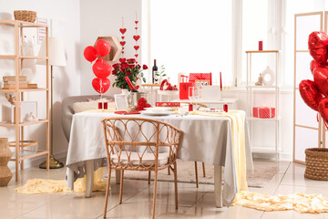 Stylish interior of room with dining table served for Valentine's Day