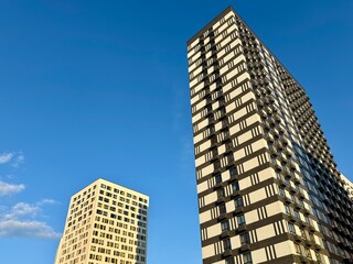 Fototapeta premium Apartment building on the background of blue sky, new building. High quality photo