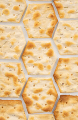 Whole grain crackers with spices and herbs isolated on white background. Dry salted cookies with crackers. Stack of various crispy wheat, rye and corn tortillas with sesame and sunflower seeds
